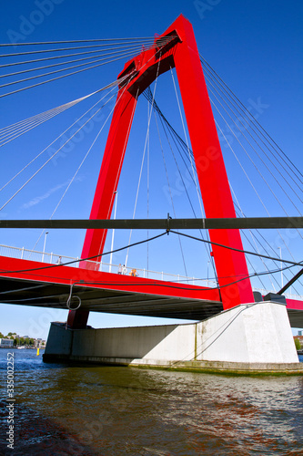 ROTTERDAM , NETHERLANDS. On July 05,  2019. A view of the  Willemsbrug    Bridge  in  Rotterdam. Bright red bridge with a total length of about 318 meters.  Was built in 1878. European travel.  © notistia