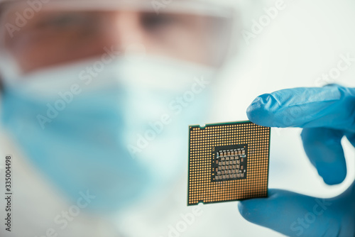 selective focus of engineer holding computer microchip photo