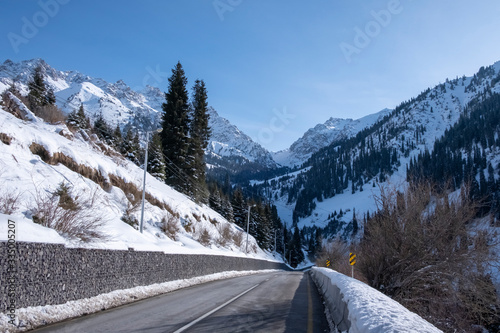 Mountain dangerous curved road in winter mountains. Winter Driving - Winter country road road through a mountains landscape.