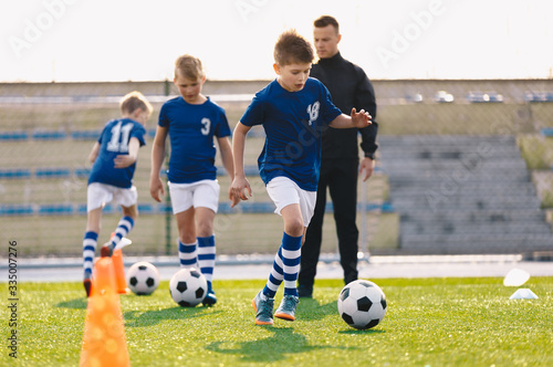 Young Boys in Sports Soccer Club on Training Unit. Kids Improve Soccer Skills on Natural Turf Grass Pitch. Football Practice Session for Children Youth Team. Junior Level Professional Soccer School