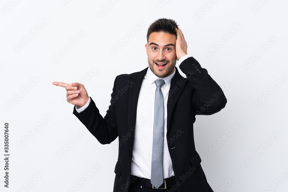 Young business man over isolated background surprised and pointing finger to the side Young business man over isolated background surprised and pointing finger to the side