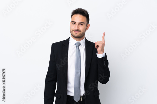 Young business man over isolated background pointing with the index finger a great idea