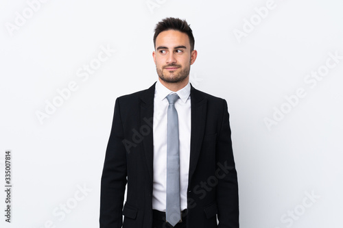 Young business man over isolated background standing and looking to the side