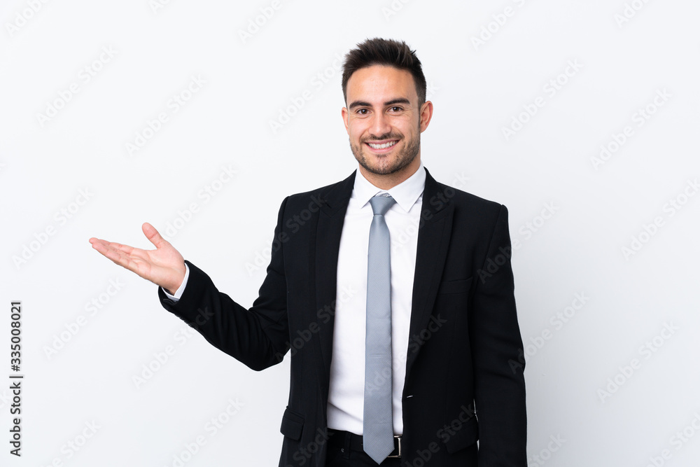 Young business man over isolated background holding copyspace imaginary on the palm Young business man over isolated background holding copyspace imaginary on the palm