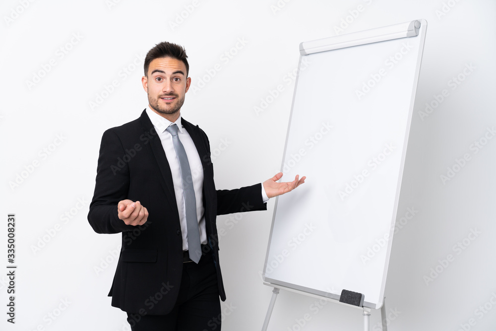 Young man giving a presentation on white board Young man giving a presentation on white board