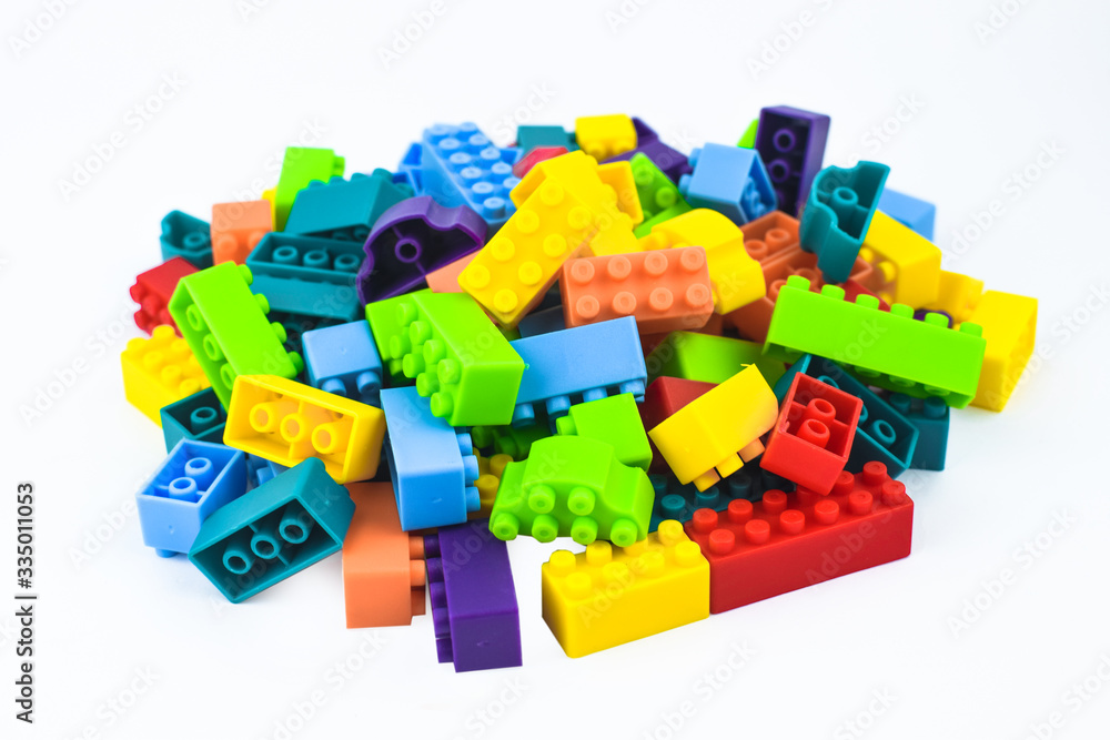 Obraz premium Portrait of different color building blocks gathered together before a white background