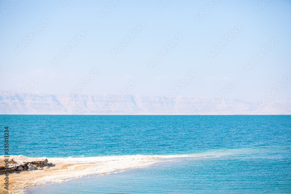 Dead sea, Jordan. Beautiful beach with salt deposits, view of Israel.