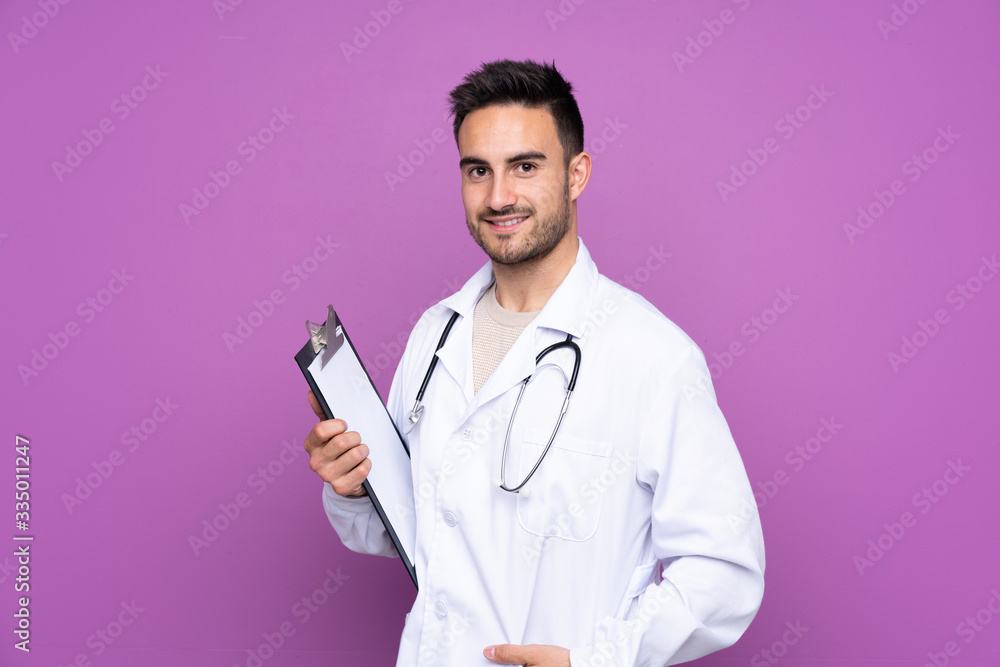 Young man wearing a doctor gown and holding a folder Young man wearing a doctor gown and holding a folder