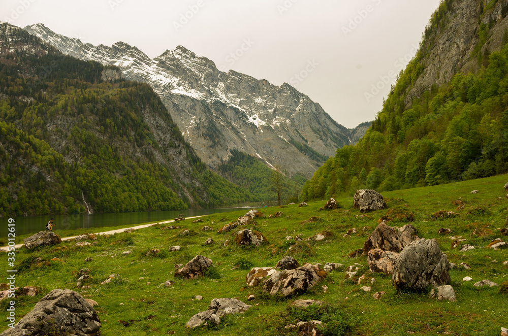 Mountains with snow, on top of the mountains with green water, green grass with stones and moss Mountains with snow, on top of the mountains with green water, green grass with stones and moss