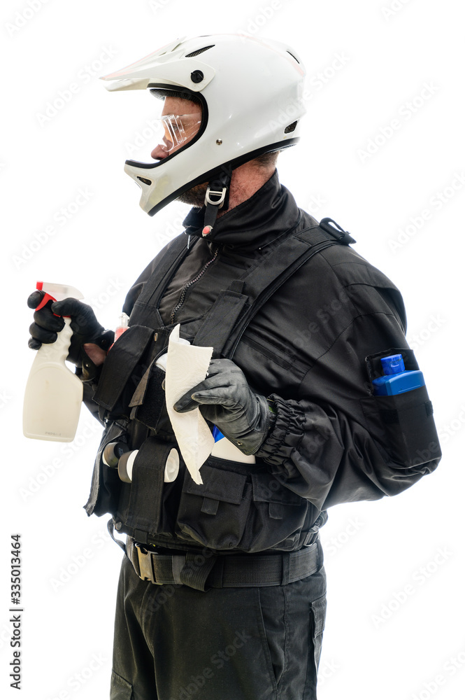 Concept Isolated portrait on white background man in a black military uniform in a white helmet with cleaning products in his hands Concept Isolated portrait on white background man in a black military uniform in a white helmet with cleaning products in his hands