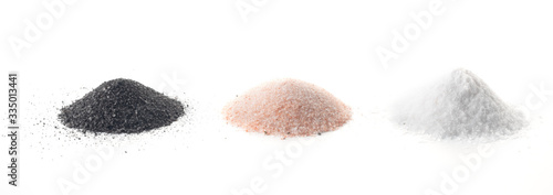 three types of salt lie on a white background - black, pink, white