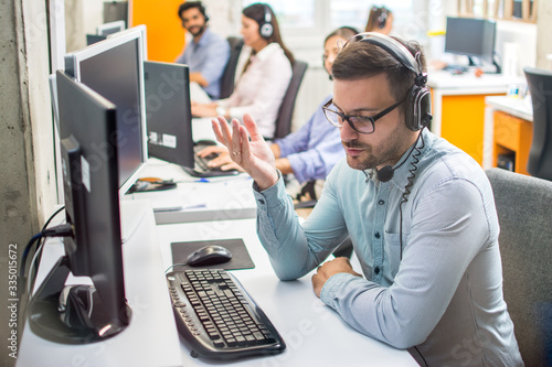 Hotline and helpdesk support operator working in office