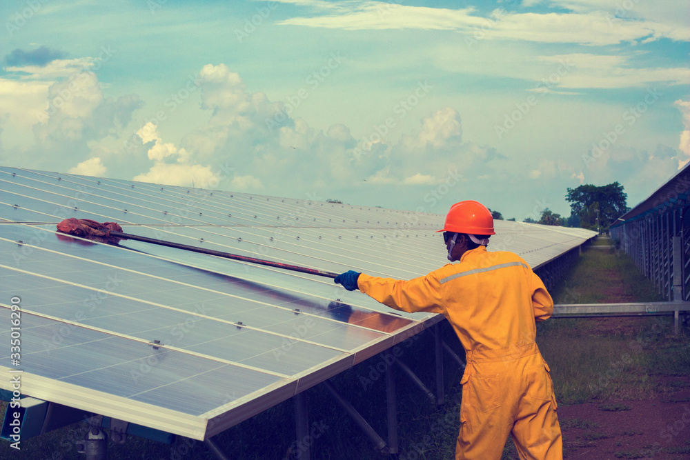 Engineering checking solar power.the concept of a man Cleaning and working on solar cell. Engineering checking solar power.the concept of a man Cleaning and working on solar cell.