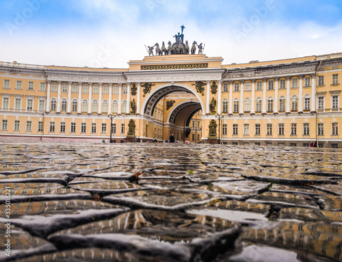 Paved the wet of rain stones at the Palace square in front of the arch of the General staff.