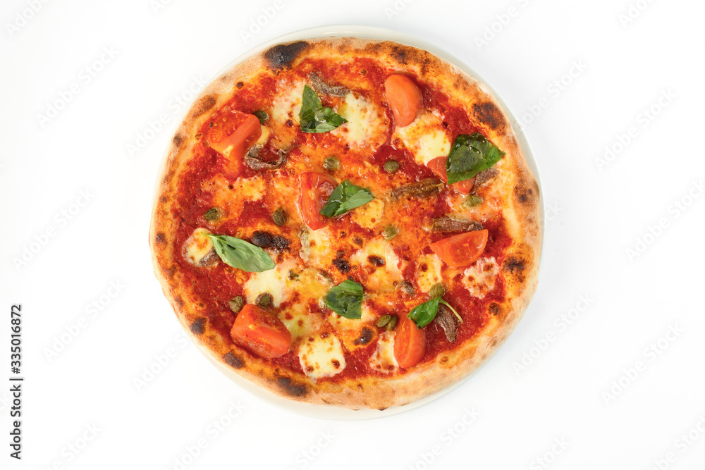 Pizza with tomatoes, cheese and basil on white isolated background