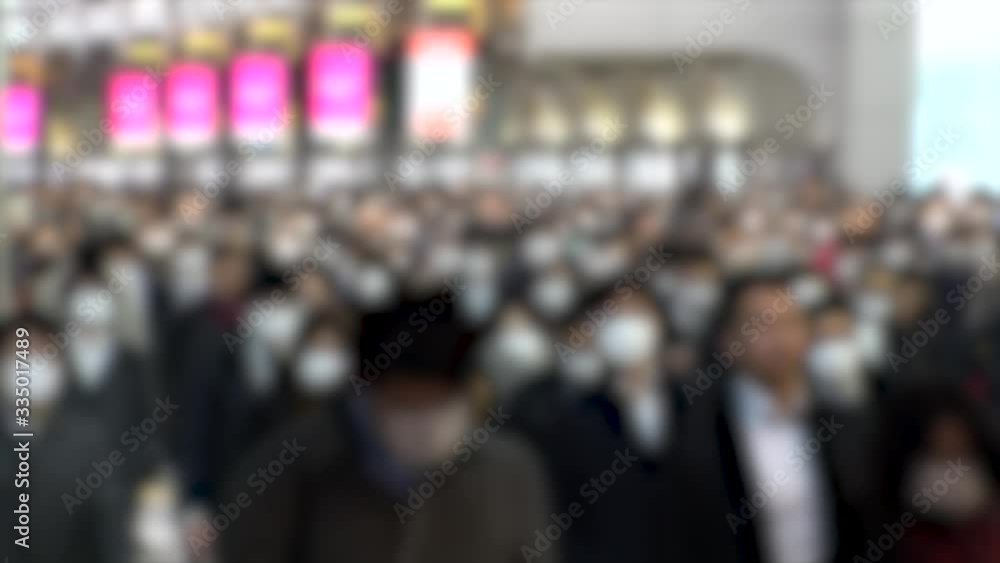 TOKYO, JAPAN - MARCH 2020 : Crowd of people walking at Shinagawa station in morning rush hour. Many commuters going to work. People wearing mask to protect from Coronavirus(COVID-19). Blurred shot. TOKYO, JAPAN - MARCH 2020 : Crowd of people walking at Shinagawa station in morning rush hour. Many commuters going to work. People wearing mask to protect from Coronavirus(COVID-19). Blurred shot.