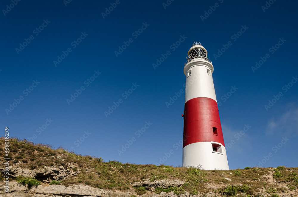 Portland Bill lighthouse at the top of the cliffs, Isle of Portland, Dorset, UK
