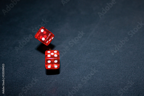 freeze red dice in motion on a dark background with copy space