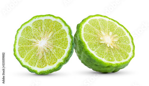 half of bergamot or kaffir with seeds on white background