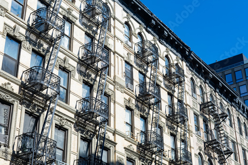 Row of Old White Stone Buildings with Fire Escapes on the Lower East Side of New York City