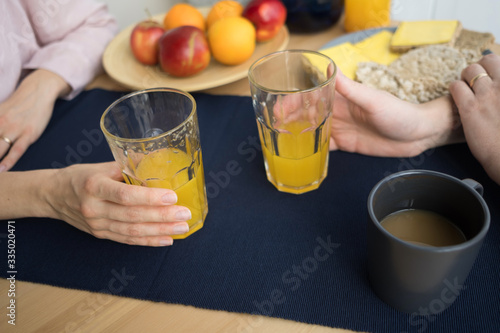 food, eating, people and healthy food concept - close up of couple having breakfast at home