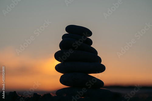 Beautiful sunny sunset over the sea  pebbles in the foreground. There is a place for text