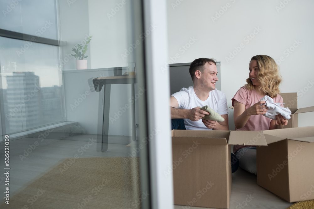 home, people, moving and real estate concept - happy couple having fun at new home.
