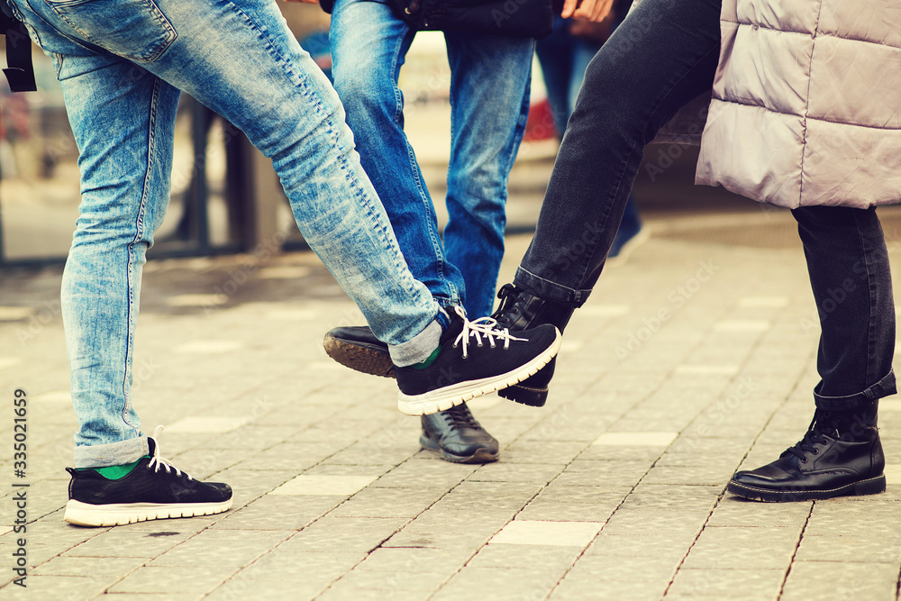 Feet bump style. Coronavirus global pandemic. Friends greeting with foots. Worldwide quarantine. Coronavirus epidemic.