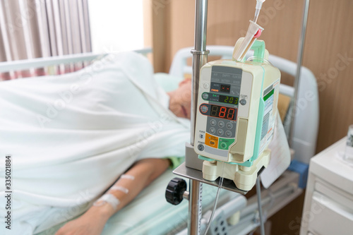 Close-up saline intravenous with patient from infusion pump at hospital.
