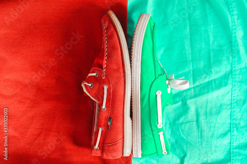 Top view of background separated by two colours and two different casual shoes. (ID: 335022003)