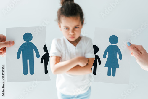 Fényképezés selective focus of man and woman holding ripped paper with separated family near