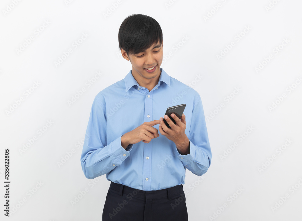 Young handsome asian business man playing smartphone with smiling isolated on white background. Young handsome asian business man playing smartphone with smiling isolated on white background.