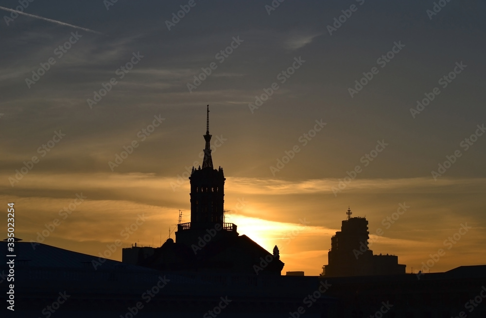 sky over the city at sunset,  town ​​silhouette in backlight.