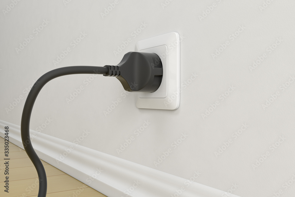 Black electric plug with cable. On white wall background Black electric plug with cable. On white wall background