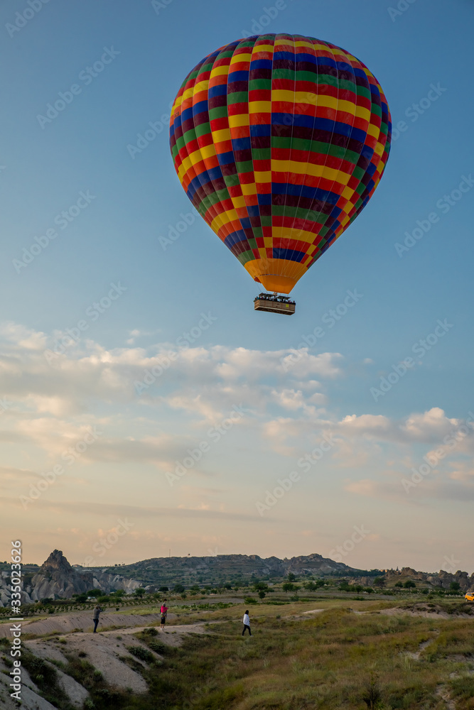 Obraz premium Hot Air balloons flying over amazing rock forms in Cappadocia