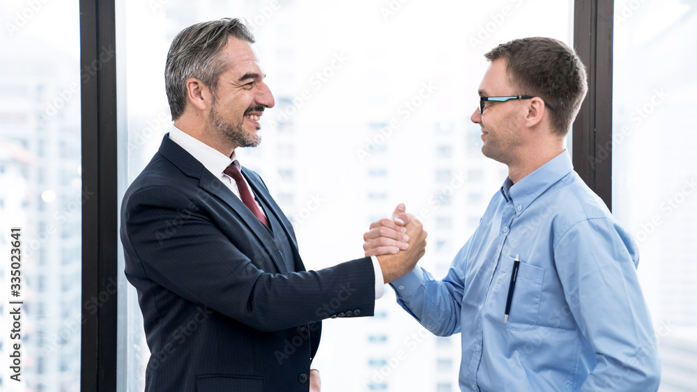 Business people shake hands when reaching a business agreement together. Business people shake hands when reaching a business agreement together.
