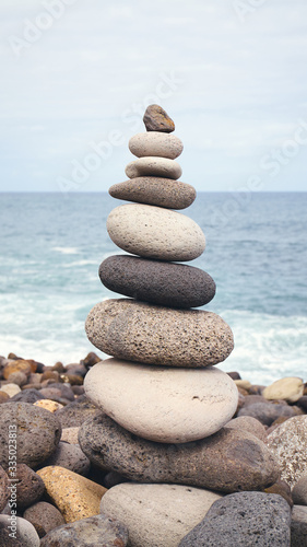 Balanced stone stack on a beach  selective focus.