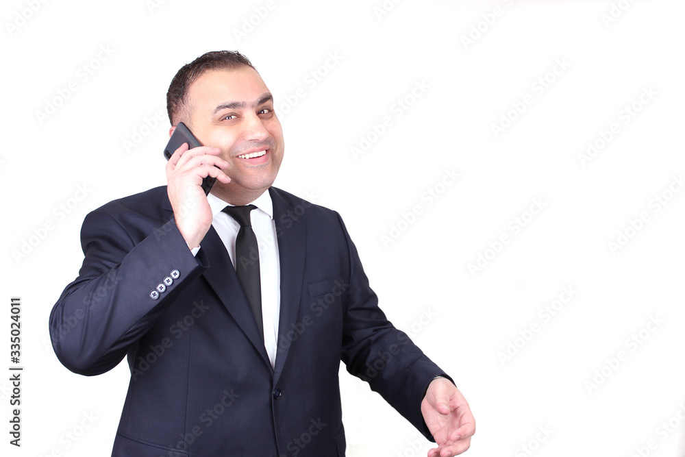 Smiling man talking by the phone. Businessman in suit and tie isolated. Business concept Smiling man talking by the phone. Businessman in suit and tie isolated. Business concept