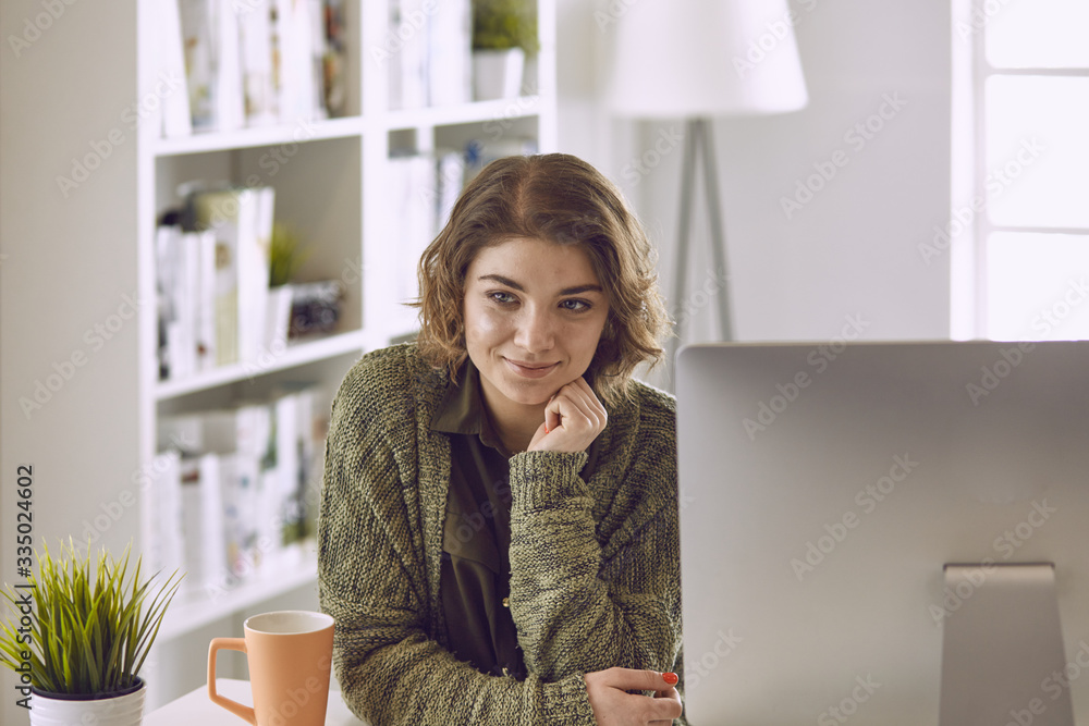 Young woman working with graphic tablet in office Young woman working with graphic tablet in office