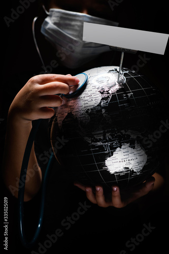 Hands of kid holding globe COVID-19 pandemic infection disease concept