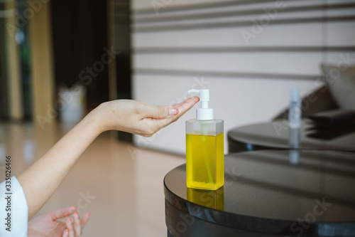 female using alcohol antiseptic gel to cleaning hand