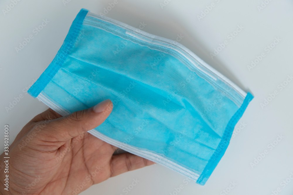Isolate light blue mask in hand for dust prevention, air pollution, Isolate light blue mask in hand for dust prevention, air pollution,