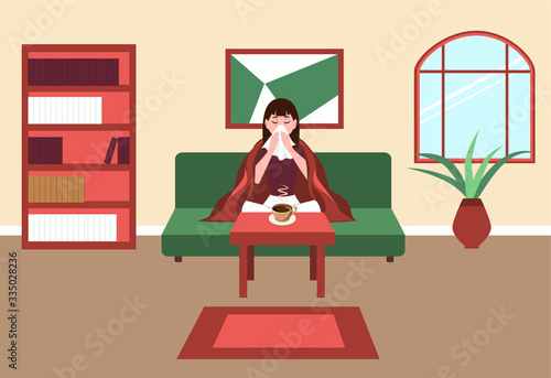 Girl with a handkerchief, sick with the flu, is sitting on the sofa in the room, opposite the table with a Cup of hot tea. Fever and cough, sore throat. The idea of medical treatment and healthcare.