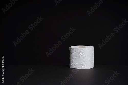 Toilet paper rolls on a black background. Cheap toilet wipes for hygiene purposes.