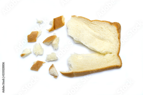 Slice of fresh bread and broken with crumbs isolated on white background.