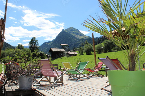 Fotografering Deck chairs in a garden in the French Alps