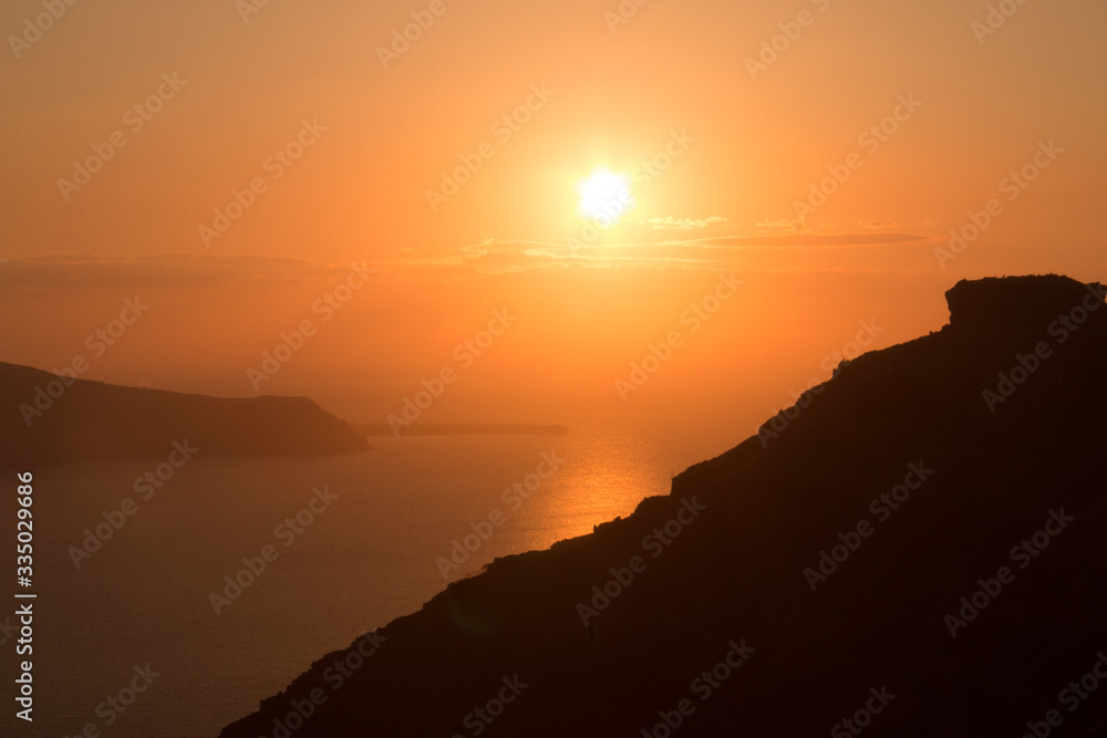 Sunset over the ocean of the islands and mountains of Crete