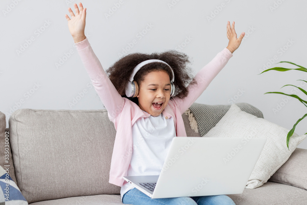 Happy young girl watching cartoons on laptop Happy young girl watching cartoons on laptop
