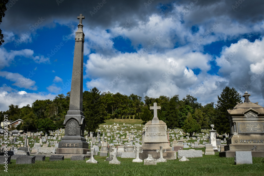 Several large headstones in a cemetery