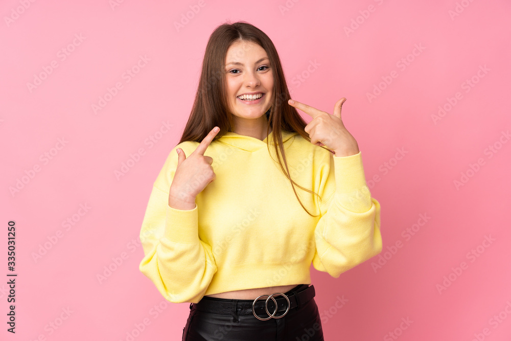 Teenager caucasian girl isolated on pink background giving a thumbs up gesture Teenager caucasian girl isolated on pink background giving a thumbs up gesture
